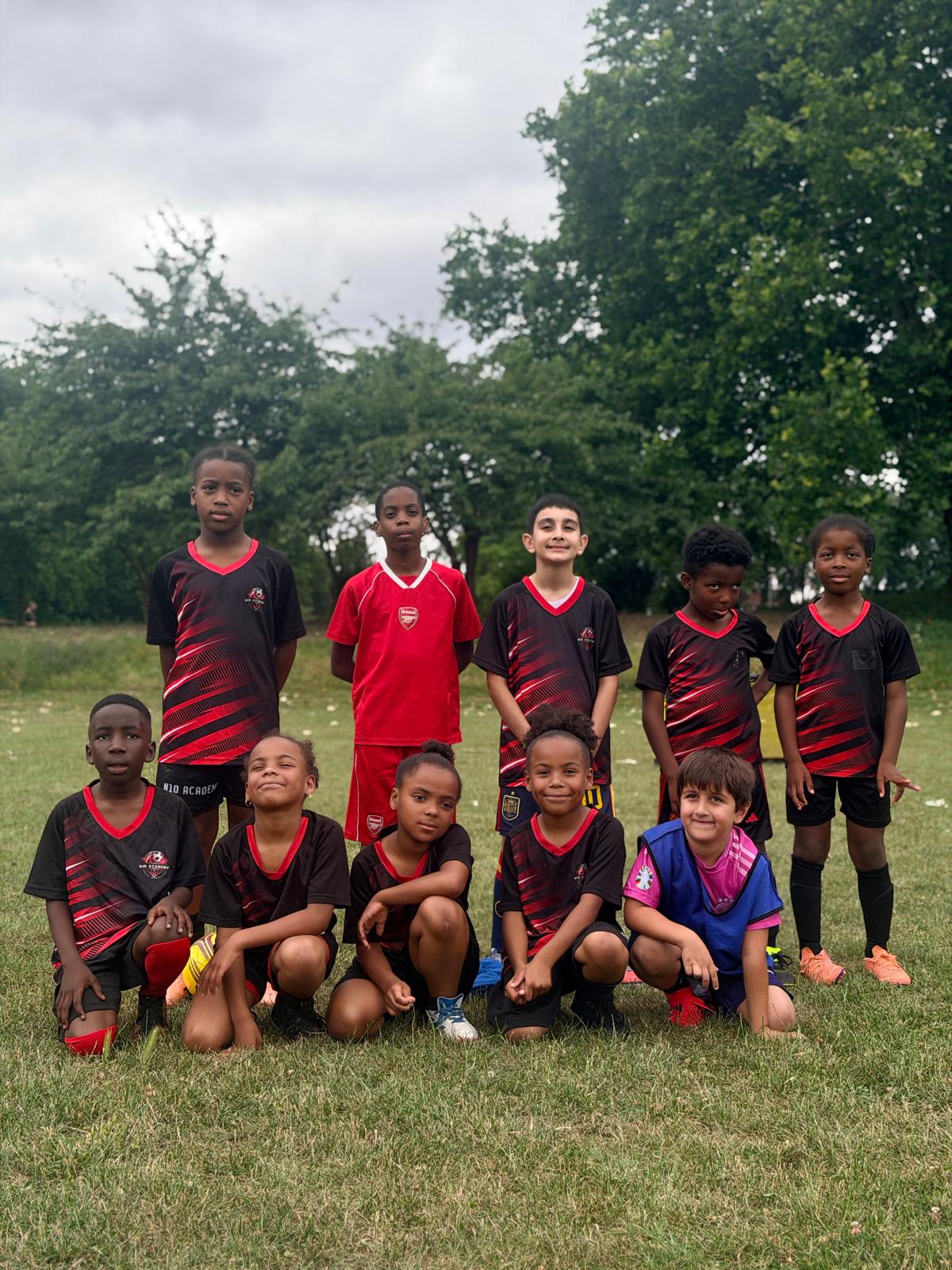 N10 Academy team photo of young players in kit on the training pitch