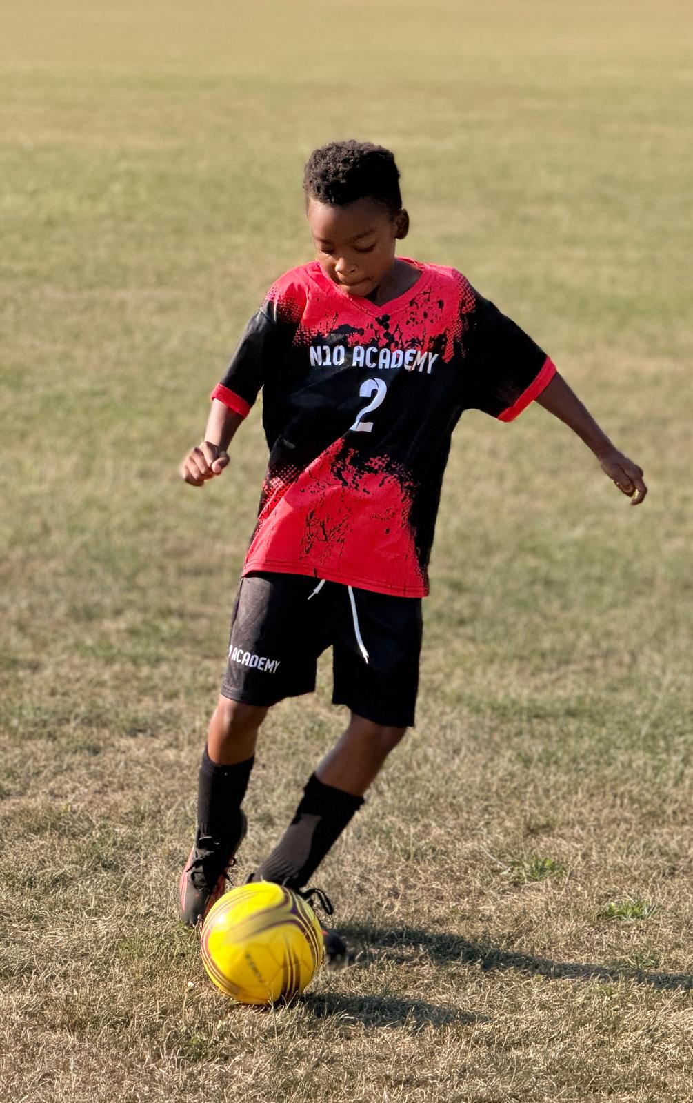 N10 Academy player smiling during a group training session